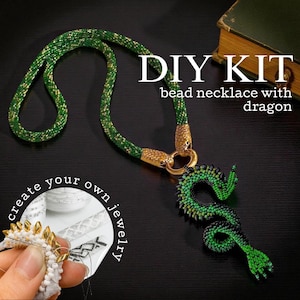 May include: A green beaded necklace with a dragon pendant. The necklace has gold accents and a DIY KIT label. The image also includes the text "create your own jewellery".