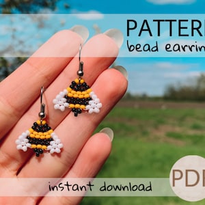 May include: A digital download pattern for beaded earrings shaped like bumblebees. The earrings are black, yellow, and white. The pattern is available as a PDF download.