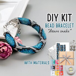 May include: DIY bead bracelet kit with materials, featuring a blue, black, and silver snake design. The kit includes beads, thread, needles, and instructions. "Azure snake" is written on the box.