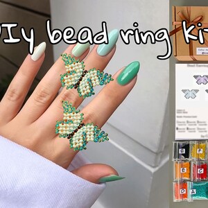 May include: DIY bead ring kit with instructions and beads in small bags. The kit includes beads in various colors, including orange, red, blue, green, and yellow. The finished ring features a beaded butterfly design.
