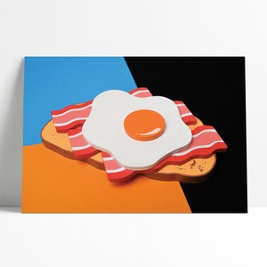 May include: A paper craft of a breakfast sandwich with a fried egg, bacon, and toast. The egg is white with a bright orange yolk. The bacon is pink and red. The toast is brown and has a rough texture. The sandwich is on a blue and orange background.