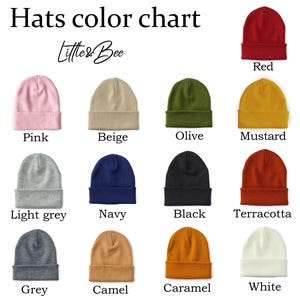 May include: Color chart showing 12 different colors of beanies. The colors are red, pink, beige, olive, mustard, light grey, navy, black, terracotta, grey, camel, caramel, and white.