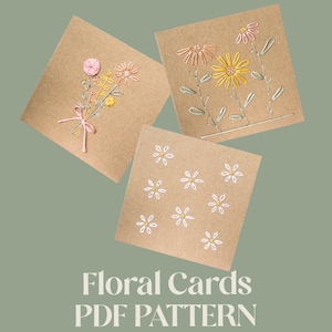 May include: Three square cards with embroidered floral designs. One card features a bouquet with a pink ribbon, another has yellow and pink flowers, and the third has white daisies. The text "Floral Cards PDF Pattern" is at the bottom.