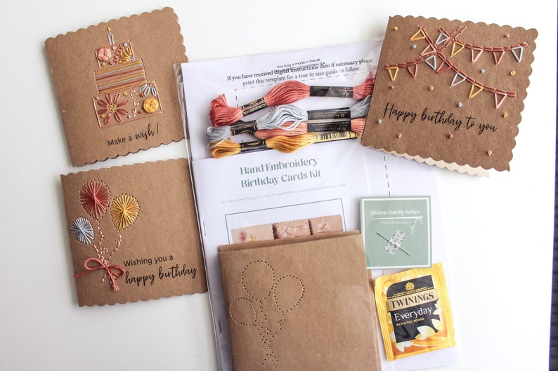 May include: A craft kit for making hand-embroidered birthday cards. The kit includes four pre-made cards with different designs, embroidery floss, a needle, and a tea bag. The cards feature designs of a birthday cake, balloons, bunting, and the text "Happy birthday to you".