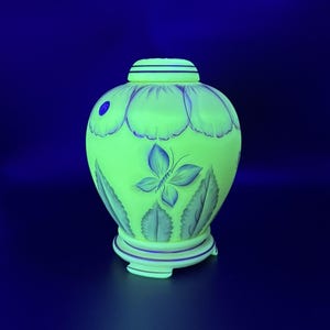 gorgeous Fenton Burmese glass ginger jar including a lid and base UV reactive with 12 Fenton family members signatures limited edition