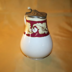 antique Staffordshire milk or syrup pitcher with a hinged lid made in the 1800&#39;s