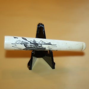 artist signed cigarette holder created by engraving scrollwork on natural material