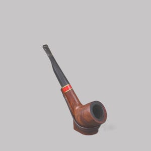 May include: A wooden tobacco pipe with a dark brown bowl and a black stem. The pipe features a red and gold band near the stem. The pipe is designed with a curved shape and is set against a neutral background.
