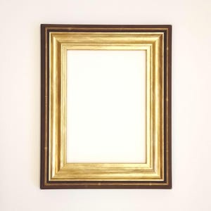 May include: A gold picture frame with a dark brown outer border. The frame is empty and ready for a photo or artwork.