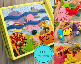 May include: A handmade felt quiet book with an ocean theme. The book features colorful felt sea creatures, including a whale, octopus, shark, and fish. The cover has a yellow border and the text "PDF Pattern" in a blue circle.