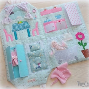 May include: A handmade, soft fabric activity book with a house theme. The open book features a kitchen, bedroom, and bathroom scenes with felt details. Includes a pink dress in a closet, a doll in a bathtub, and a flower pot.