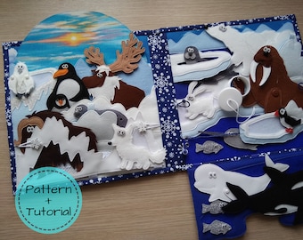 May include: A handmade felt quiet book with an arctic theme. The book features various arctic animals, including penguins, polar bears, and a walrus, set against a backdrop of snowy landscapes and a sunset sky. The text "Pattern + Tutorial" is visible.