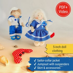 May include: Two handmade 5-inch dolls dressed in sailor outfits. One doll wears a blue and white sailor jacket and blue pants. The other doll is in a blue sailor dress. A red crab-shaped toy is also present. The image includes text that says "PDF+ Video" and "5-inch doll clothing".