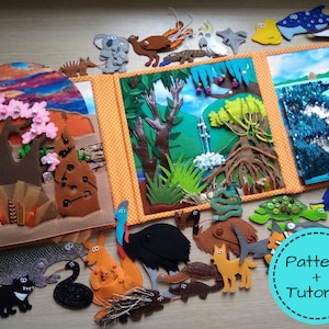 May include: A felt quiet book depicting Australian wildlife and landscapes. The book includes a kangaroo, emu, and koala. The text "Pattern + Tutorial" is in a blue circle. The book is open, showing colourful felt scenes.