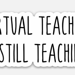 May include: A white sticker with the black text "VIRTUAL TEACHING IS STILL TEACHING." The text is in a simple, sans-serif font. The sticker has a white border and a slightly irregular shape.