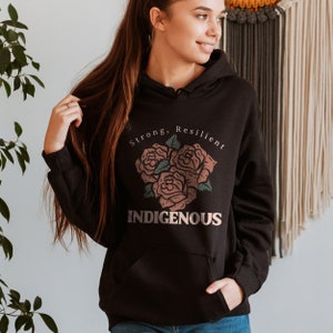 May include: Black hooded sweatshirt with a graphic design of three roses and the text "Strong, Resilient, Indigenous".