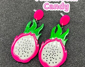 May include: A pair of pink and green dragon fruit earrings. The earrings are made of plastic and have a shiny finish. The earrings are shaped like a dragon fruit, with a white center and pink and green edges.