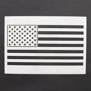 Puede incluir: Una plantilla blanca de la bandera estadounidense. La plantilla tiene 50 estrellas en el campo azul y 13 rayas rojas y blancas.