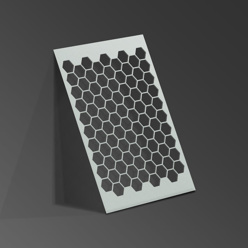 May include: White stencil with a honeycomb pattern cut out. The honeycomb pattern is made up of black hexagons.