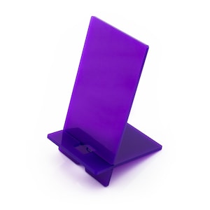 May include: Purple plastic phone stand. The stand is angled to hold a phone upright.