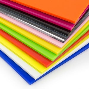 May include: A stack of colorful acrylic sheets in various shades of blue, green, yellow, orange, red, pink, black, and white.