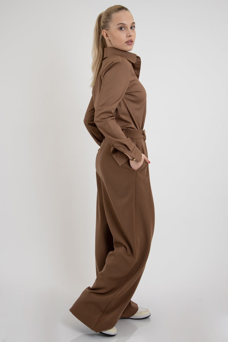May include: A brown long-sleeved shirt with a collared neckline and a matching pair of wide-leg pants.