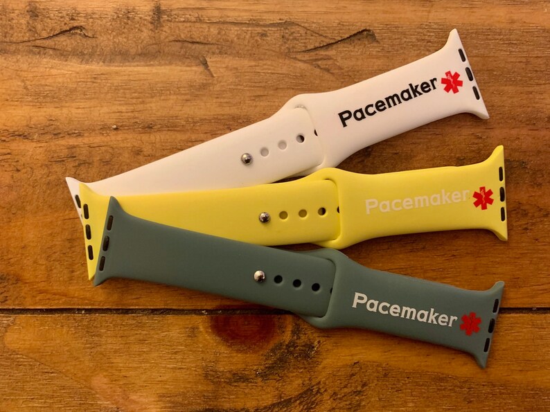 May include: Three different colored silicone watch bands with the word "Pacemaker" and a red star printed on them. The bands are white, yellow, and green.
