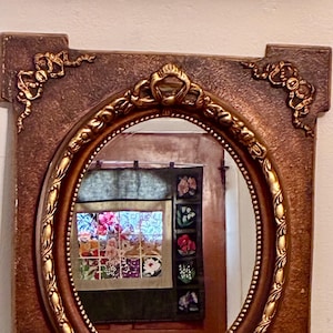 Vintage Ornate Framed Mirror – Oval Glass with Embossed Gold Details, 23.5” x 19”