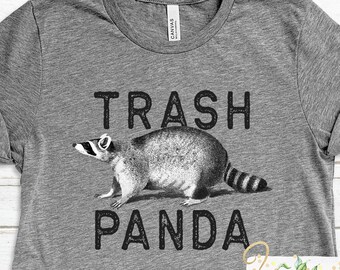 May include: Gray t-shirt with a black and white illustration of a raccoon and the text "Trash Panda".