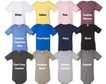 May include: Twelve baby onesies in various colors, including white, yellow, pink, heather maroon, heather columbia blue, true royal, navy, black, dark grey heather, heather stone, athletic heather, and asphalt.