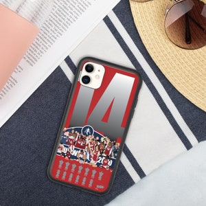 May include: A black phone case with a red and white design. The case features a large number "14" and a group of people in red and white uniforms. The text "World 2020" is visible below the group of people.