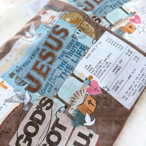 May include: Brown and blue religious-themed artwork with the words "JESUS" and "GOD'S GOT YOU." The design includes doves, a cross, and text that reads "JESUS PAID IT ALL." The artwork is layered with a receipt-like design.