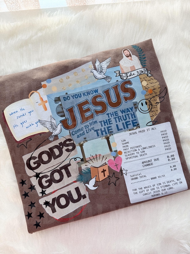 May include: Brown fabric with a collage design featuring the text "GOD'S GOT YOU" and "JESUS." The design includes doves, a cross, stars, and a receipt-like graphic with text. The overall theme is religious.