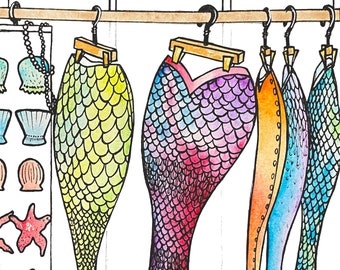 May include: Five mermaid tails hanging on hangers. The tails are made of fabric and are decorated with colorful scales. The tails are in various colors, including green, pink, blue, and orange. The tails are hanging in front of a white background.