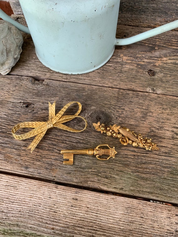 Three vintage gold tone brooches