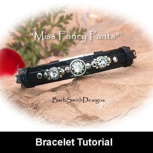May include: Black leather bracelet with silver accents and rhinestones. The bracelet is on a brown rock surface. The text "Miss Fancy Pants" is above the bracelet. The text "Barb Smith Designs" is below the bracelet. The text "Bracelet Tutorial" is below the image.