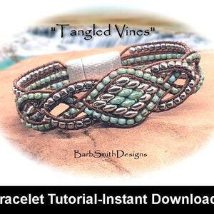 May include: A close-up of a beaded bracelet with a silver clasp. The bracelet is made with brown leather cord, turquoise beads, and silver beads. The bracelet is called "Tangled Vines" and is a tutorial for making the bracelet.