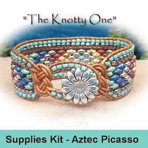 May include: A beaded leather bracelet with a silver flower charm. The bracelet is made with turquoise, blue, red, and yellow beads. The text "The Knotty One" is above the bracelet. The text "Supplies Kit - Aztec Picasso" is below the bracelet.