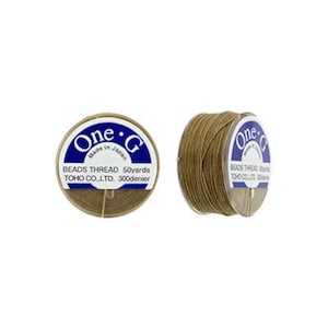 May include: A spool of brown beading thread, labeled "One-G Beads Thread 50yards TOHO CO.,LTD. 300denier" and "Made in Japan".