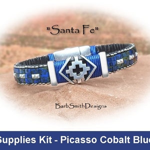 May include: A blue and silver beaded bracelet with a silver charm that says "Santa Fe". The bracelet is on a brown, rocky surface. Supplies Kit - Picasso Cobalt Blue.