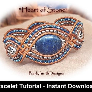 May include: A brown leather bracelet featuring a blue gemstone and silver beads. The bracelet is woven with a knot pattern and has a silver charm with a symbol on it. The bracelet is titled "Heart of Stone".