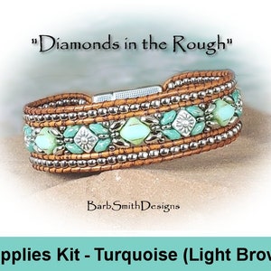 May include: A handcrafted bracelet with a light brown leather band, adorned with silver beads and turquoise-colored beads. The bracelet features a magnetic clasp and decorative floral accents. The text "Diamonds in the Rough" is displayed above the bracelet.