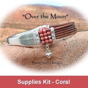 May include: A coral-colored beaded bracelet with a silver heart charm. The bracelet is made with leather and a silver clasp. The text "Over the Moon" is visible above the bracelet. The text "Barb Smith Designs" is visible below the bracelet. The text "Supplies Kit - Coral" is visible at the bottom of the image.