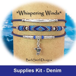 May include: A supplies kit for a beaded bracelet with a denim theme. The kit includes blue and silver beads, cord, and a charm. The bracelet is called "Whispering Winds" and is made by BarbSmithDesigns.