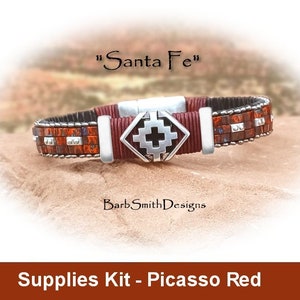 May include: A beaded bracelet kit with a red, black, and silver color scheme. The kit includes a silver charm with a cross design. The kit is labeled "Supplies Kit - Picasso Red".