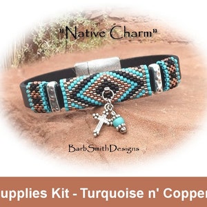 May include: A turquoise and copper beaded bracelet with a black leather strap and a silver clasp. The bracelet has a turquoise and copper cross charm hanging from it. The bracelet is labelled "Native Charm" and "Barb Smith Designs".