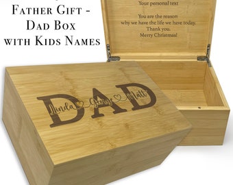 May include: A wooden box with a hinged lid. The lid is open and the inside of the box is visible. The box is engraved with the word "DAD" and the names "Linda", "George", and "Matt". The lid is engraved with the text "Your personal text You are the reason why we have the life we have today. Thank you. Merry Christmas!"