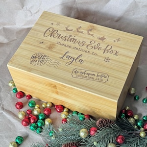 May include: A wooden Christmas Eve box with the text "Christmas Eve Box" and "Please deliver to: Layla" engraved on the lid. The box also has a stamp that says "North Pole Express" and a sticker that says "Do not open before December 24th".