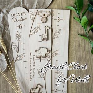 May include: A wooden growth chart for the wall, featuring engraved height markings and decorative animal cutouts. The chart includes the text "Growth Chart for Wall" and the name "Oliver Wilson". The chart is designed to measure height.
