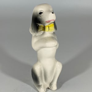 Vintage ceramic toy poodle figurine with yellow bow